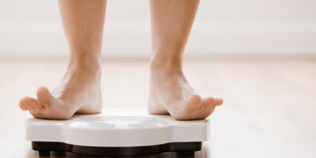 Caucasian woman's feet standing on scale