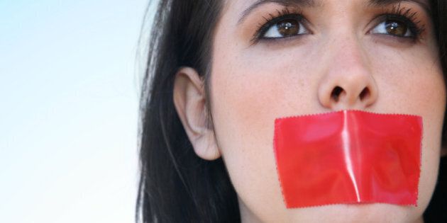 Woman With Red Tape Over Her Mouth Unable To Speak