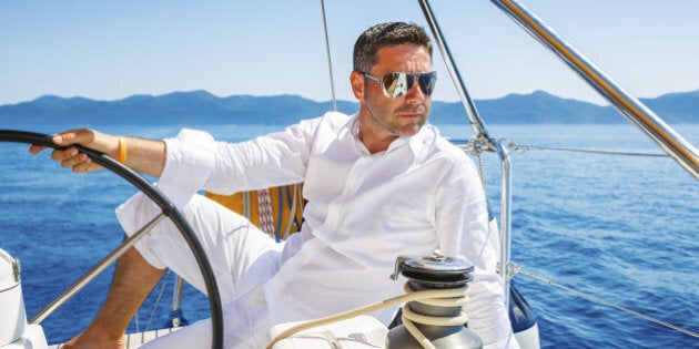 Handsome man sailing with sailboat.