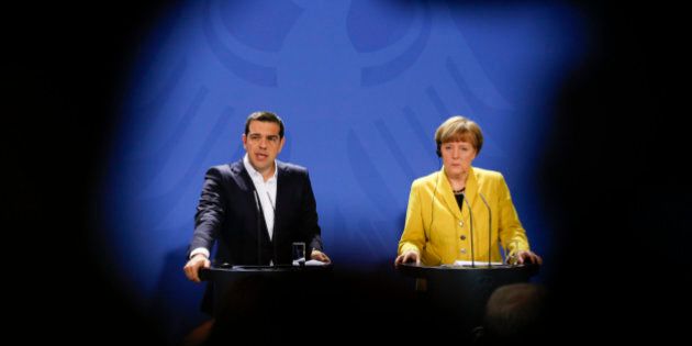 In this photo taken with the silhouette of a television camera in the foreground, German Chancellor Angela Merkel, right, and the Prime Minister of Greece Alexis Tsipras brief the media during a bilateral meeting with at the chancellery in Berlin, Monday, March 23, 2015. (AP Photo/Markus Schreiber)