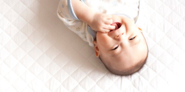 Baby girl lying down and smiling