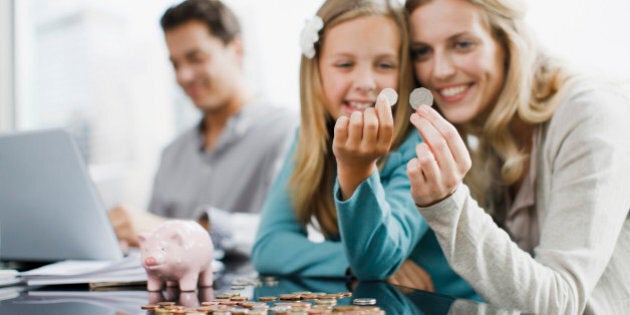 Mother and daughter comparing coins