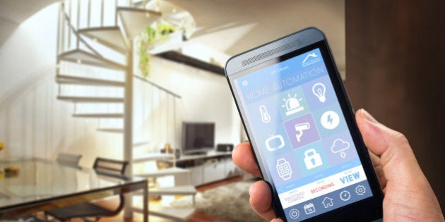 smart house, home automation, device with app icons. Man uses his smartphone with smarthome security app to unlock the door of his house.