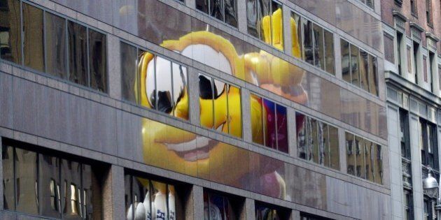 UNITED STATES - NOVEMBER 21: Honey Nut Cheerios' Buzzbee balloon is reflected in a building as it heads down to Herald Square during Macy's 75th anniversary Thanksgiving Day Parade. (Photo by Susan Watts/NY Daily News Archive via Getty Images)