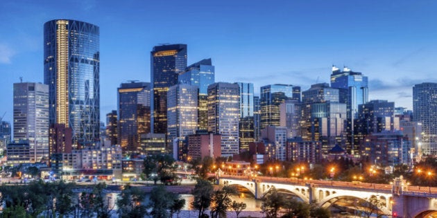 Calgary skyline at night with Bow River and Centre Street Bridge.