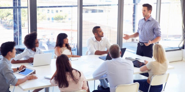 Businessman presenting to colleagues at a meeting