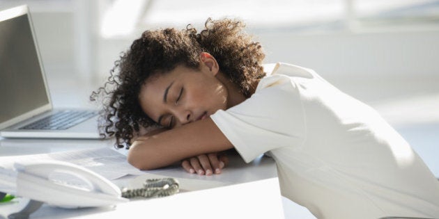 Woman napping with her head resting on desk