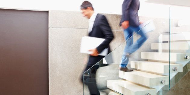 Business colleagues walking on flight of stairs