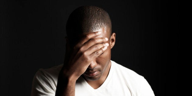 African American man hiding his face