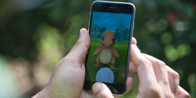 In this Friday, July 22, 2016 photo, a Pokemon Go player attempts to catch Charmander, one of Pokemon's most iconic creature, in New Delhi, India.
