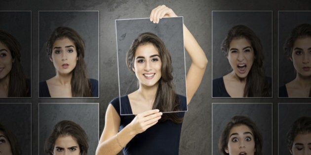 Woman holding photo in front of her face