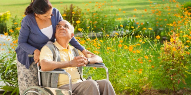 Senior woman with husband in wheelchair