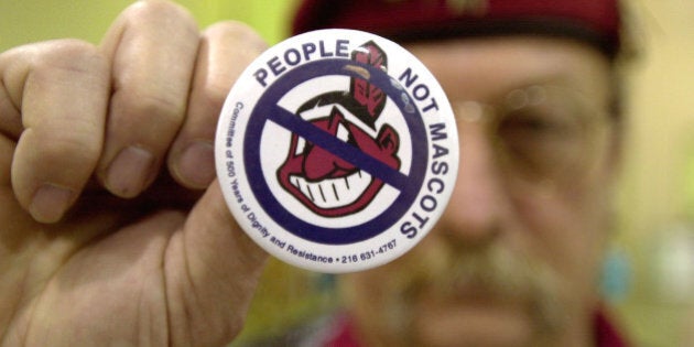 COLUMBUS, OH - JANUARY 1: Powwow attendee Sonny Hensley holds an anti-mascot button to protest using Indians as mascots for sports teams at the 10th Annual New Years Eve Sobriety Powwow January 1, 2003 in Columbus, Ohio. The Ohio Center for Native American Affairs sponsored the event, attracting people from several U.S. states as well as Canada. (Photo by Mike Simons/Getty Images)