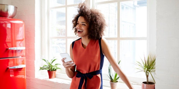 Young woman laughing in a trendy apartment