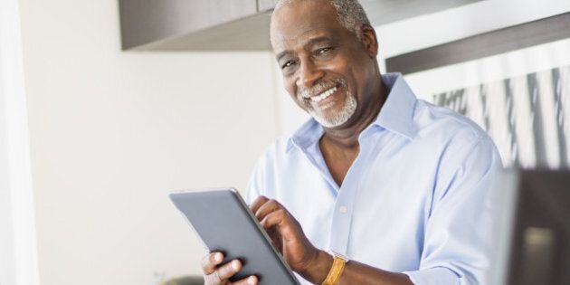 USA, New Jersey, Jersey City, Portrait of senior man using digital tablet in office