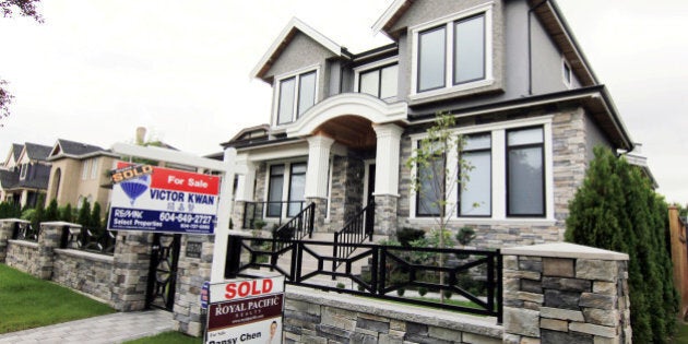 Realtors' signs are hung outside a newly sold property in a Vancouver, B.C., Canada neighbourhood where houses regularly sell for C$3-C$4 million (US$2.7-3.6 million) September 9, 2014. REUTERS/Julie Gordon/File Photo