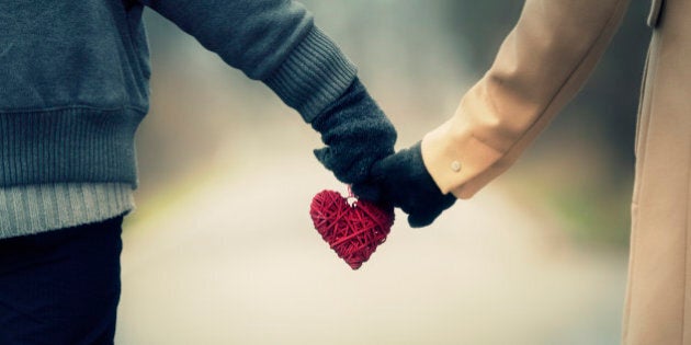 Couple in love holding hearts.