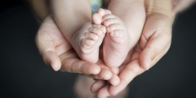 little toes in mom's hands