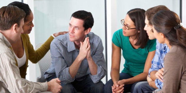 Meeting Of Support Group Looking At Each Other Talking