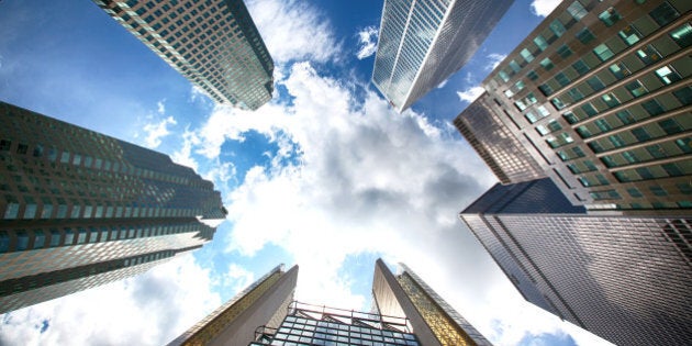 An image taken from below of skyscrapers of Toronto. Financial center of Toronto. Business center of Toronto, Canada. Office high-rise buildings in Toronto. Business and money of Toronto. Wide-angle view of tall office buildings from below.