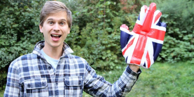 Man waving with a novelty Union Jack hand