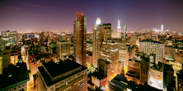 Night long exposure cityscape of Manhattan from a rooftop.Beautiful colors and interesting composition including 1 World Trade Center and the Madison Square Park and Flatiron District skyscrapers.