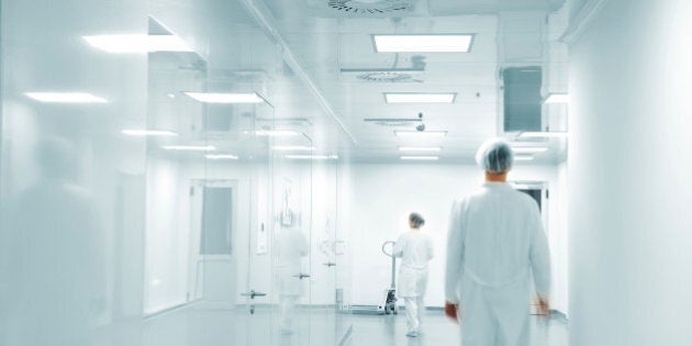 Working people with white uniforms in modern factory environment