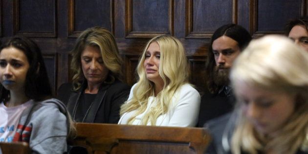 (Pool photo by Jefferson Siegel) - Kesha (center in white) cries as she learns she will not be released from her record label contract in Manhattan Supreme Court on Friday, February 19, 2016. A judge said she would not allow Kesha to leave her record label. (Pool Photo by Jefferson Siegel/NY Daily News via Getty Images)