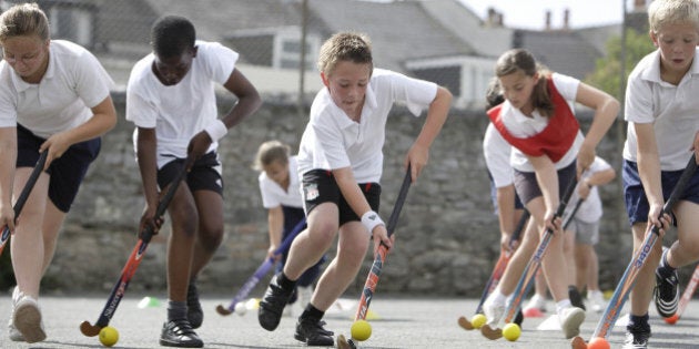 school children playing hockey