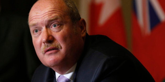 British Columbia Finance Minister Mike de Jong speaks during a news conference with Canada's Finance Minister Jim Flaherty and Ontario Finance Minister Charles Sousa after signing an agreement to set up a cooperative capital markets regulator, on Parliament Hill in Ottawa September 19, 2013. Canada's federal government and two of its provinces will set up a common securities regulator to try to replace the current patchwork of provincial regulation, but most provinces, notably Quebec, have not signed on. Flaherty and his counterparts from Ontario, home to the country's predominant capital market, and British Columbia unveiled details of their plan on Thursday. REUTERS/Chris Wattie (CANADA - Tags: POLITICS BUSINESS)