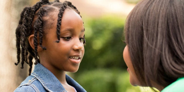 African American mother talking with her daughter.