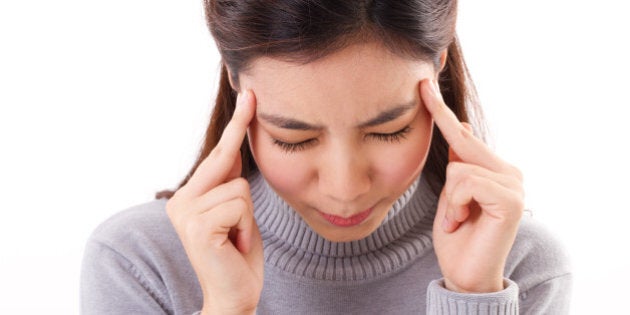 close up portrait of sick woman with headache, winter clothing studio shot