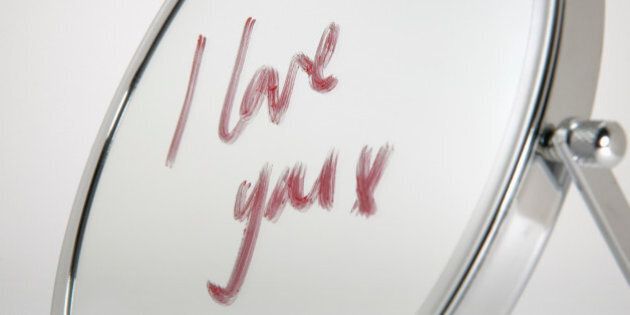Detail view of the words ?I love you? written on a mirror in lipstick