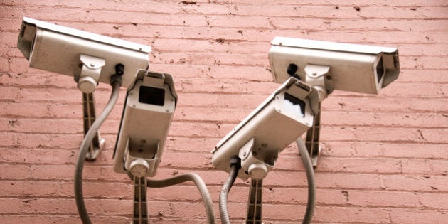 Four security camereas on exterior wall of building