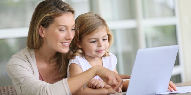 little girl looking at laptop...