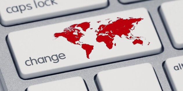 An extreme close-up of a keyboard, focused on the shift key which now says 'change' and has a red map of the world.