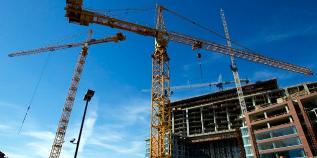 Cranes stand at a condominium construction site in downtown Vancouver, British Columbia, Canada, on Wednesday, Aug. 7, 2013. The Canada Mortgage and Housing Corp. is scheduled to release housing starts figures on Aug. 9. Photographer: Ben Nelms/Bloomberg via Getty Images