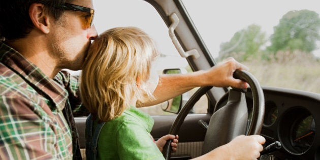 Father and son at wheel of a car