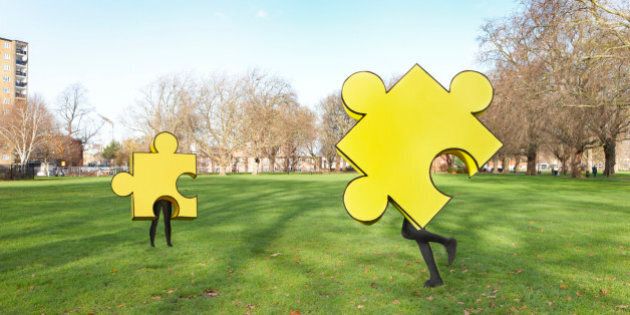 Two puzzle pieces running in the park