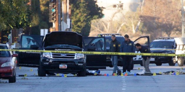 Authorities investigate the scene where a police shootout with suspects took place, Thursday, Dec. 3, 2015, in San Bernardino, Calif. A heavily armed man and woman opened fire Wednesday on a holiday banquet, killing multiple people and seriously wounding others in a precision assault, authorities said. Hours later, they died in a shootout with police. (AP Photo/Jae C. Hong)