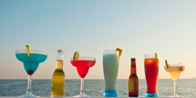 row of cocktails on boat rail