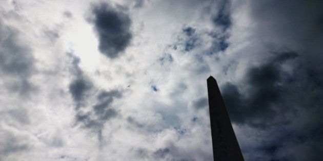 a science fiction type obelisk against a cloud filled sky