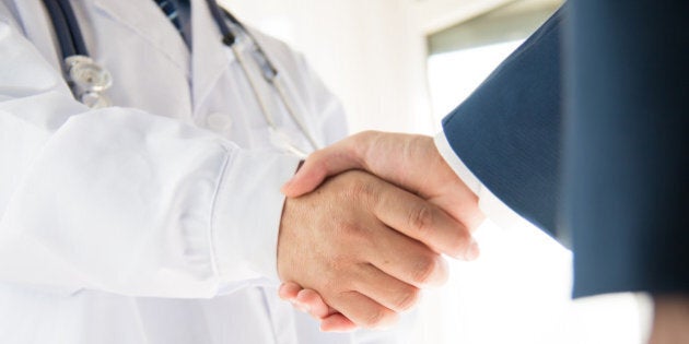 Doctor and businessman shaking hands