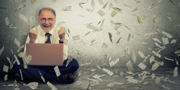 Senior business man using a laptop building online business making money dollar bills cash falling down. Money rain. IT entrepreneur online job success economy concept