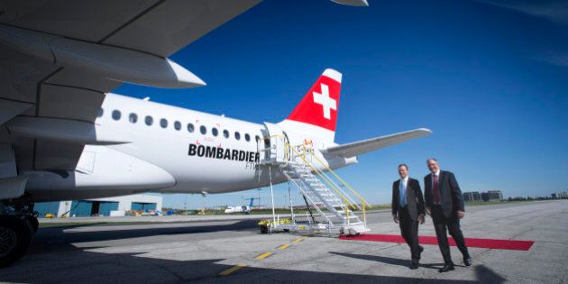 Rob Dewar, vice president of CSeries program for Bombardier Aerospace, right, and Fred Cromer, president of commercial aircraft for Bombardier Aerospace Corp., walk in front of the new Bombardier Inc. CS100 airplane during an event at the company's facility in Toronto, Ontario, Canada, on Thursday, Sept. 10, 2015. Bombardier Inc. is refocusing the sales campaign for its tardy CSeries jet on established, 'marquee' airlines, a shift away from reliance on lessors and small carriers. Photographer: Kevin Van Paassen/Bloomberg via Getty Images
