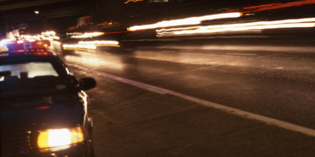 Police car and highway traffic at night