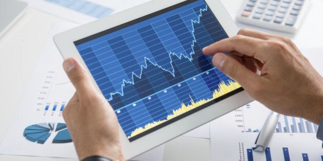 Close Up Of A Businessman Analyzing Graph On Digital Tablet