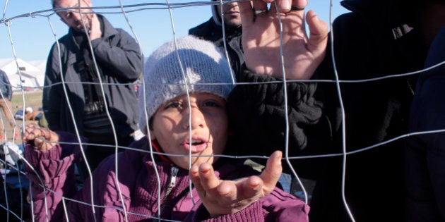 IDOMENI, GREECE - DECEMBER 3: Stranded migrants gather at the Greek-Macedonian border December 3, 2015 near the northern village of Idomeni, Greece. Macedonian authorities are allowing only people from the war-wracked countries of Syria, Afghanistan and Iraq to cross from Greece on their way to other European Union countries, leading to protests from those from other countries who have been blocking the crossing for all since Wednesday. (Photo by Milos Bicanski/Getty Images)