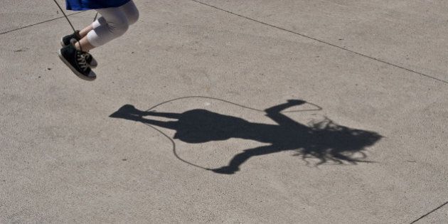 Strong shadow of a girl jumping rope