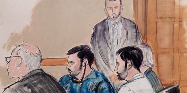 In this courtroom sketch, a U.S. marshall stands guard in the background as defense attorney John Reilly, left, Francisco Flores, center in blue shirt, Efrain Campos, second from right, and defense attorney Rebekah Poston make an initial appearance in Manhattan federal court on Thursday, Nov. 12, 2015, in New York. An indictment unsealed on Thursday accuses Campos and Flores, nephews of Venezuela's first lady, of conspiring to smuggle cocaine into the United States. (AP Photo/Elizabeth Williams)
